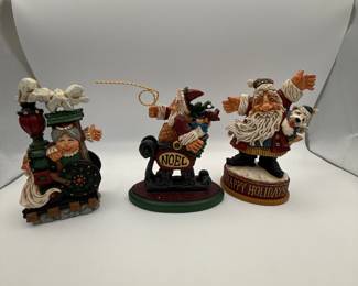David Frykman Santa Figures. Included are: a whimsical Santa with a 'NOEL' sign, a festive Santa with a puppy, and a cheerful Mrs. Claus with gift-laden sled. Each piece captures the joy of the holiday season.