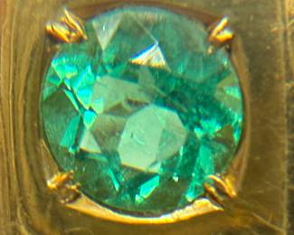 this is an 18 karat gold ring with eight .06 princess cut diamonds and a green stone that measures at 6.2 mm. Weight is shown both Troy ounces and in grams. The ring is a size 11