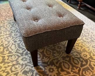 Newly recovered gray ottoman