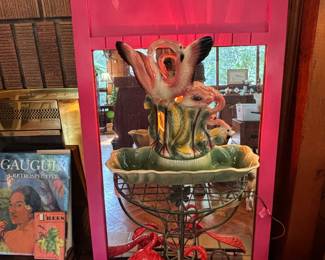 We love this vintage flamingo lamp! Those are hangers, just below it..