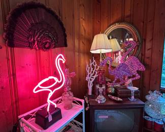 The turkey feather display hangs above neon pink! One of my favorite vintage gold mirrors is above that old TV.