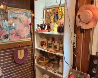 OK, so this room is the second kitchen and there’s all kinds of stuff in here. This is just one corner… I do like that cheerful hibiscus watercolor AND that odd painting on the top shelf