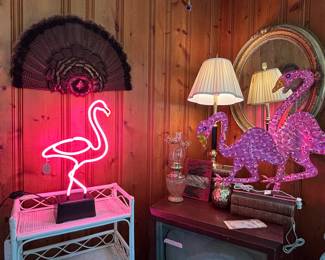 The turkey feather display hangs above neon pink! One of my favorite vintage gold mirrors is above that old TV.