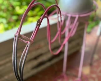 This is very sharp looking outdoor flamingo planter that’s been freshly painted. We decided to let her hold the silver orb for awhile;)