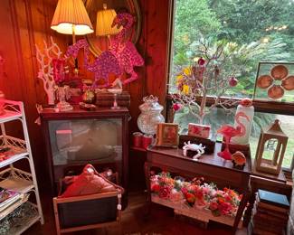 Those are lawn flamingoes that light up! They work…I like that shell art in the window, very classy…And the bright and cheery table floral/candle piece under the table…I've added that beautiful white ceramic coral piece