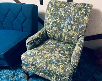 Third piece of sectional on the left side of pic.
Pretty floral armchair.