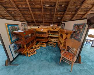 Art studio with hundreds of art pieces that included handmade benches, each with their own painted design that includes a story behind the design origin, drawings, paintings, wall hangers, and so much more.