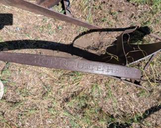 The "John Deere 191 plow" refers to a specific model of walking plow produced by John Deere, likely a horse-drawn model. The "191" designation typically refers to the beam or frame of the plow. These plows were common during the era of horse-drawn agriculture and are now often sought after for restoration or as historical artifacts