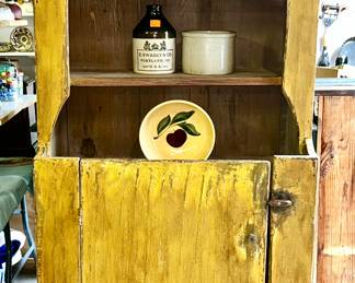 Primitive cupboard with mustard color paint