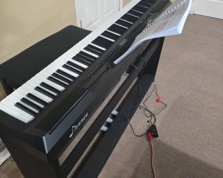 Does piano has weighted keys, many different sounds, foot pegs, a bench, and a stand.