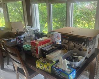 Kitchen table with chairs and a bench. And many other kitchen items