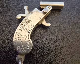There are two different vintage key fobs / antique guns here for sale