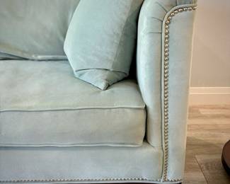 Turquoise tuxedo-style sofa with nailhead trim and matching throw pillows