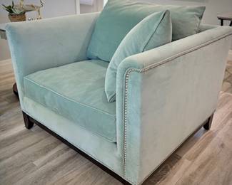 Turquoise tuxedo-style armchair with nailhead trim and matching throw pillows
