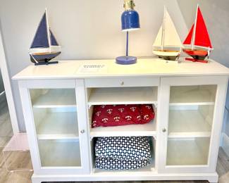 Low white dresser with nine shelves and one shallow drawer