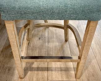 Five turquoise upholstered barstools. Seat height is 24 inches. Wood leg legs with metal kick bar.