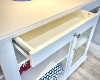 Low white dresser with nine shelves and one shallow drawer