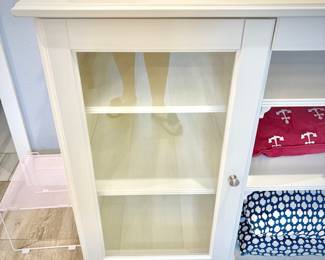 Low white dresser with nine shelves and one shallow drawer
