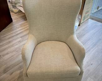 Off-white high-back armchair with nailhead trim