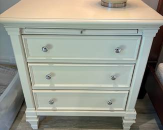Second of two white night stands, each with three drawers and pullout tray