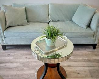 Living Room: Turquoise tuxedo-style sofa, matching armchair, off-white high-back armchair, and two wood circular end tables.