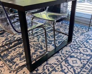 H84 - $475 SET. Ikea Tranebo Dining Table. Measures 36.5" wide x 87" long x 30" tall. Overall very good condition - does have some surface marks. 6 Ikea Tobias Clear & Chrome Plated Chairs. 5 are in very good condition. 1 has a crack - still useable.