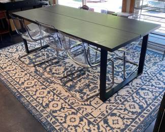 H84 - $475 SET. Ikea Tranebo Dining Table. Measures 36.5" wide x 87" long x 30" tall. Overall very good condition - does have some surface marks. 6 Ikea Tobias Clear & Chrome Plated Chairs. 5 are in very good condition. 1 has a crack - still useable.