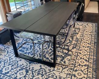 H84 - $475 SET. Ikea Tranebo Dining Table. Measures 36.5" wide x 87" long x 30" tall. Overall very good condition - does have some surface marks. 6 Ikea Tobias Clear & Chrome Plated Chairs. 5 are in very good condition. 1 has a crack - still useable.