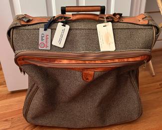 S129 - $40 - Hartmann Tweed Leather Rolling Carry On Luggage Garment Bag Suitcase. Great condition. Some spotting on name tag. See all photos. All mechanics (zippers, wheels, handles) work as they should. 22"w x 19"d x 9"t