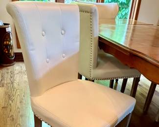 4 Matching faux leather chairs w/nail head trim - sold separate from the table