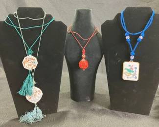 Chinese Necklace Assortment Featuring Hand-Painted Porcelain and Carved Cinnabar