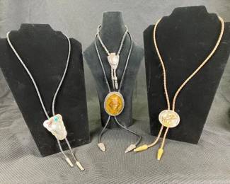Group of Four Western Bolo Ties Featuring Leather, Snake Skin, and Mixed Metal