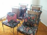 Four Iron Chairs and a Glass Top table