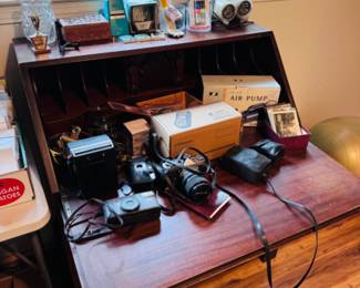 Secretary desk, office supplies and cameras