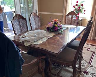 Dining table.  Florals. Rugs.