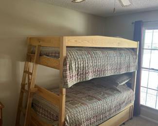 Handcrafted solid wood bunk beds with ladder and barely used mattresses.