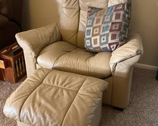 Comfy leather recliner with matching storage ottoman.