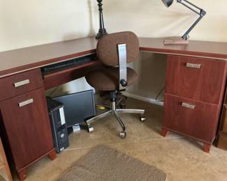 Corner desk with keyboard tray and file drawer.