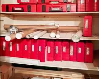 Closet filled with lots of tools, prints, blueprints, maps, model shipbuliding supplies