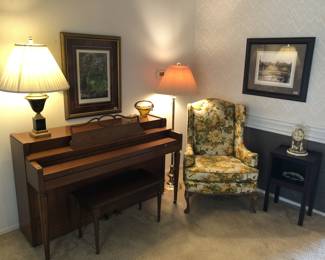 Yellow floral wingback chair, piano, lamp, table, decor