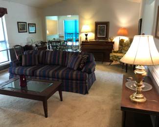Sofa, display coffee table, lamps, art, low shelves