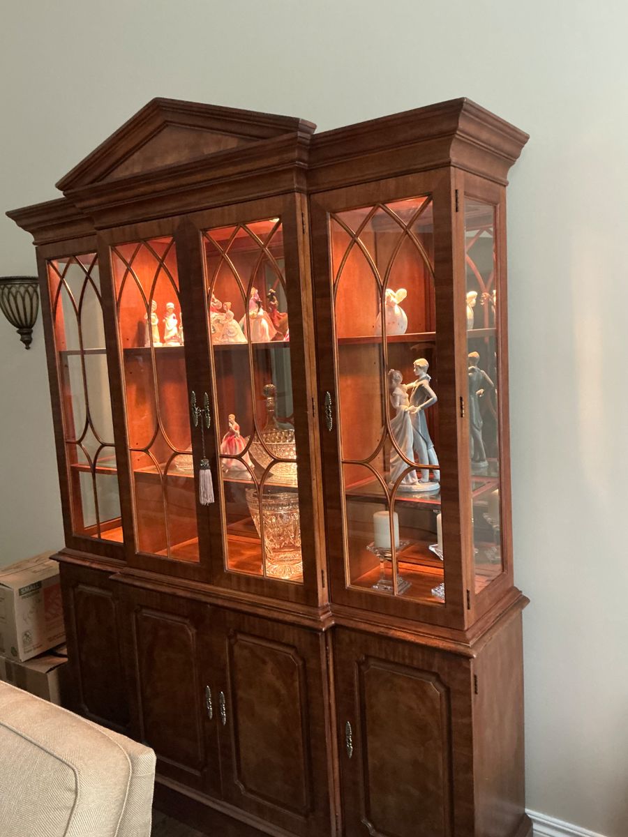 This is a stunning mahogany solid furniture piece by Henredon. It comes with glass doors, interior deck lights, three lower drawers, and adjustable side shelves. All doors are lockable with a provided tasseled key. $1500.