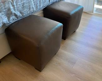 Two brown leather footstools/ottomans. They are versatile piece that can add extra seating or style to any room. Measures 19x19 inches. $125 for the pair.