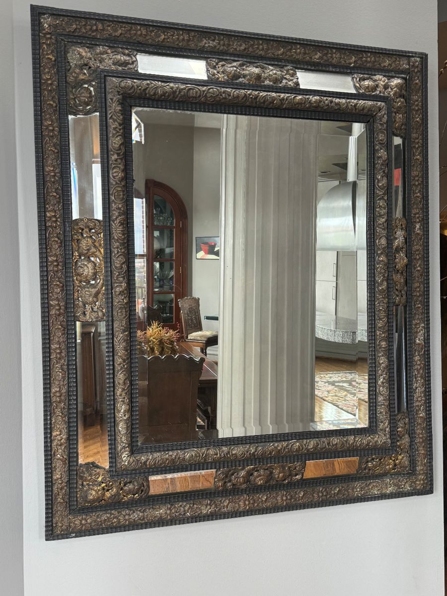Franco Flemish style cushion mirror in an ebonized and repoussé brass frame $1200
41.5in x 48 in
