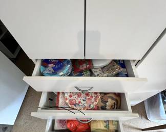 Tons of items for the party planner including paper plates, napkins for every holiday and plastic silverware. Drawers full.