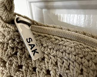 Two rooms have a variety of purses