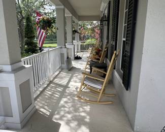 Outdoor rocking chairs and hanging baskets.