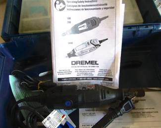 Cased Dremel with a few bits.