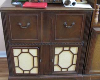 Vintage radio/record player that has been converted into a liquor cabinet.