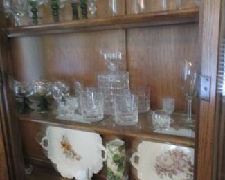 Photo of items in china hutch. hutch does match table and chairs. P;ates from Germany and clear glass items/